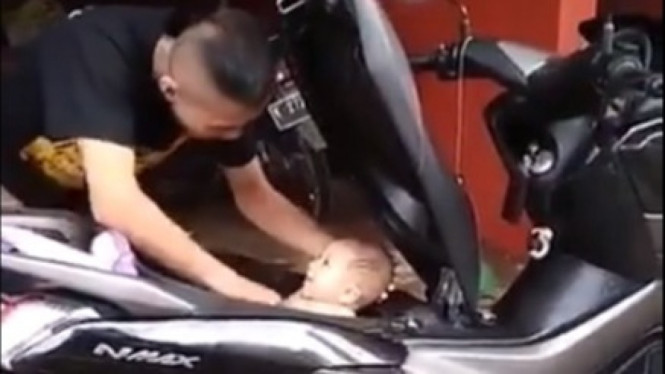 Memandikan bayi di bagasi motor