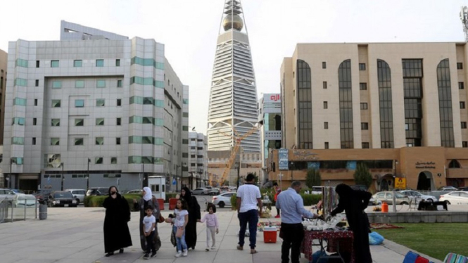 Visitors walk near the King Fahd Library in Riyadh