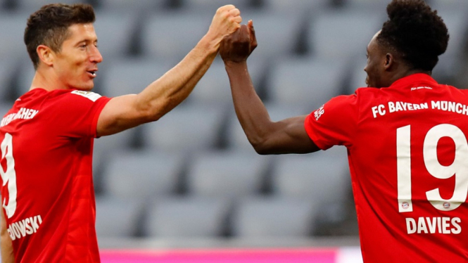 Striker Bayern Munchen, Robert Lewandowski merayakan gol bersama rekannya Alphonso Davies