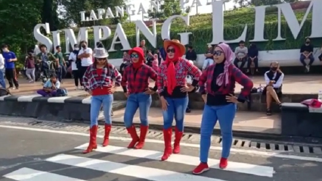 Emak-emak berlenggak-lenggok di zebra cross Simpang Lima Semarang. (ANTV/ Didiet Cordiaz)