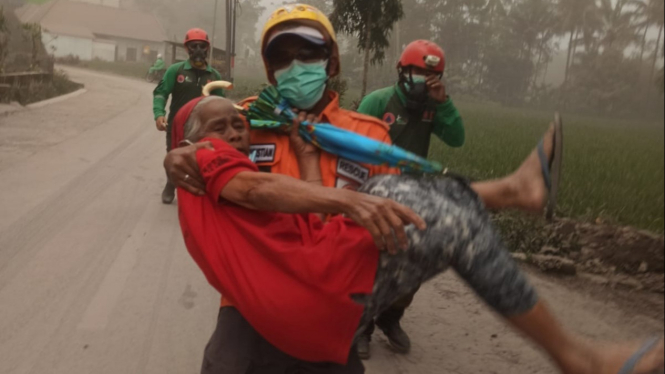 Petugas evakuasi lansia akibat awan panas Semeru.