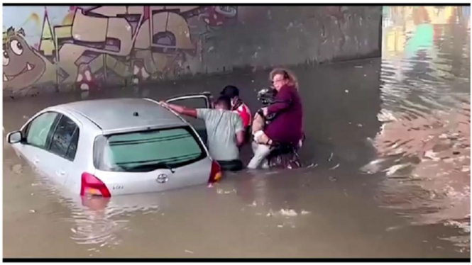 Mobil terjebak banjir. Evakuasi korban banjir dilakukan.