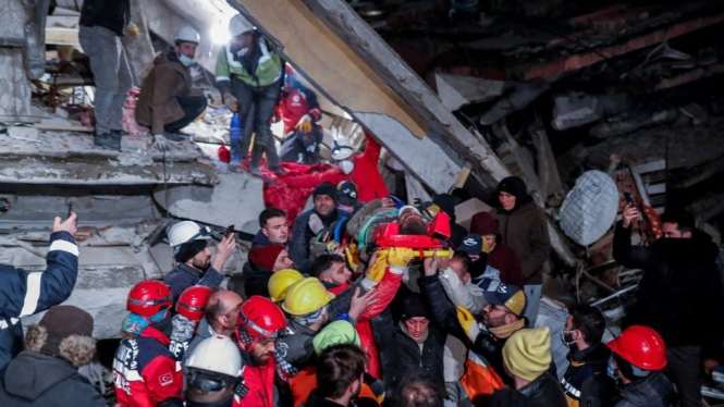 Tim SAR evakuasi warga dari balik reruntuhan akibat gempa di Turki.