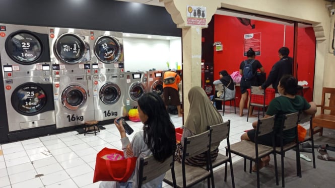 Aktivitas pelanggan salah satu laundry koin di Denpasar, Bali.