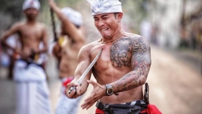 Seorang Pria Mencoba Menusuk Diri Sendiri dalam Tradisi Ngurek