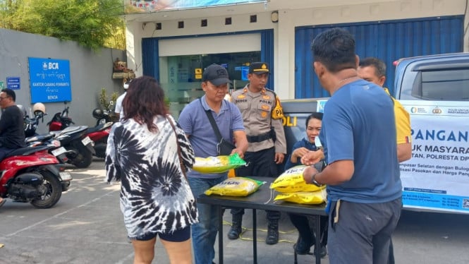 ejumlah warga antre tertib membeli beras