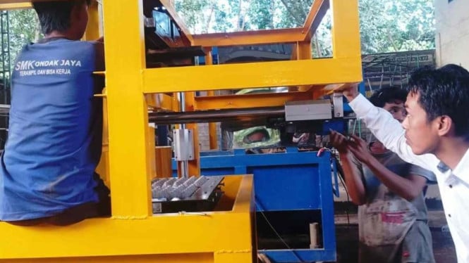 Kepala Sekolah SMK Ondak Jaya Harmain Saat Meninjau Mesin Tray Telur
