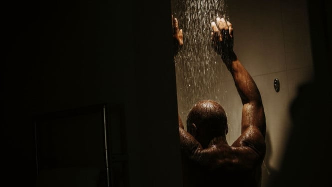 Seorang pria sedang mandi malam