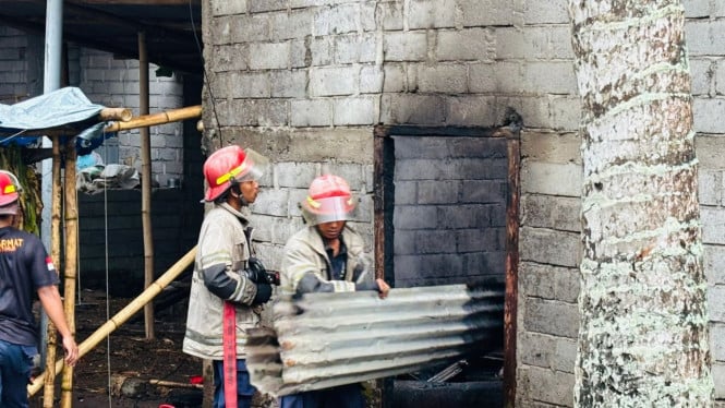 Petugas memadamkan kebakaran oven tembakau di Desa Leming