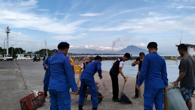 Polisi bersama masyarakakt membersihkan area pelabuhan