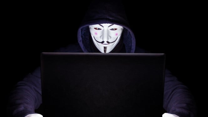 Hacker anonim sedang meretas korbannya