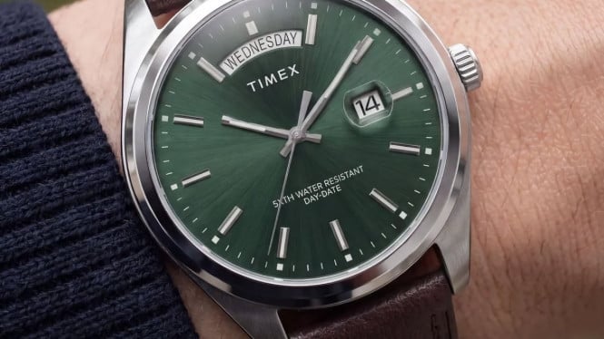 Image 26: The Timex Legacy Day and Date on a wrist, featuring a green sunray diall.