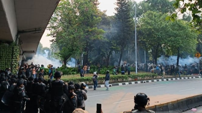 Petugas menembakkan gas air mata ke arah pengunjuk rasa di Jakarta.