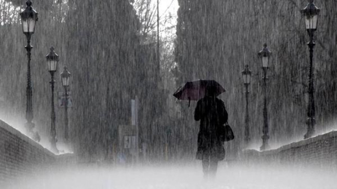 Ilustrasi warga berjalan menggunakan payung saat hujan
