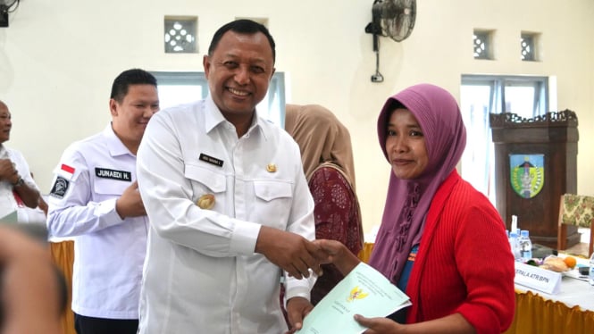 Pjs Bupati Kediri membagikan sertifikat Program PTSL.