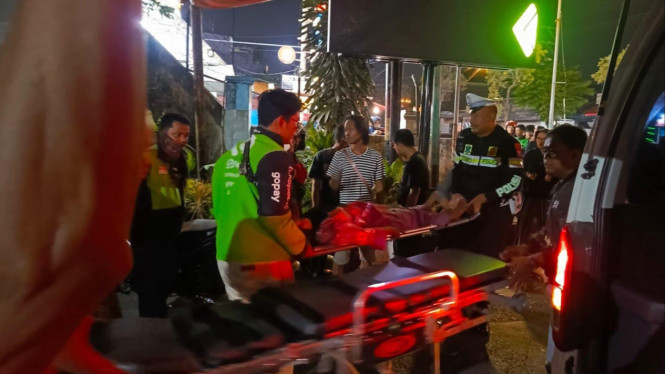 Ojol, warga dan polisi mengevakuasi korban kecelakaan di Gresik.