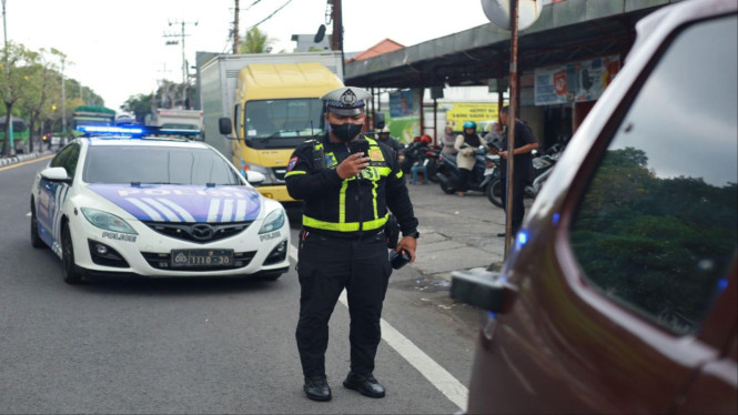 Polisi saat menggunakan ETLE Handheld.