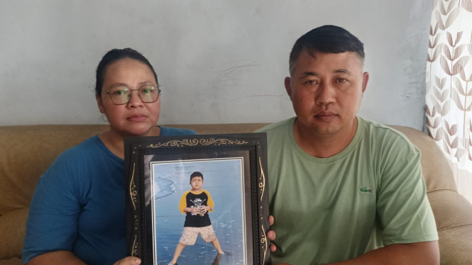 Pelda Riyadi dan istri menunjukkan foto anaknya