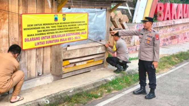 Polsek Penengahan bersama Pemerintah Desa Bakauheni melakukan pemasangan banner larangan berjualan di pinggir Jalan Lintas Sumatera (Jalinsum).