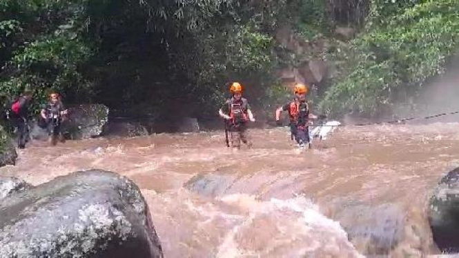 Petugas mengevakuasi pengunjung Air Terjun Way Lalaan yang terjebak