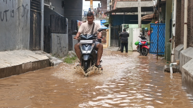 Warga saat melintasi banjir