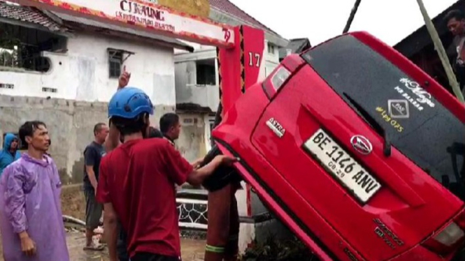Warga evakuasi mobil terseret banjir bandang.