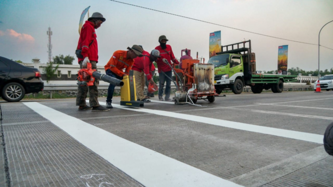 Pemasangan pita kejut di jalan raya Jombang.