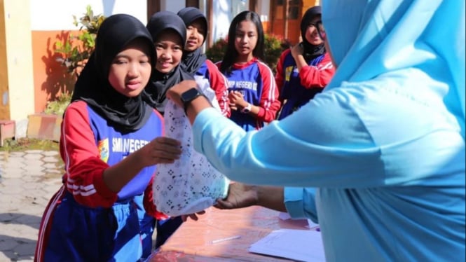 Pelajar di Kota Batu saat menerima makanan gratis dan susu.