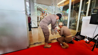 Petugas menggembok pintu masuk Mall Center Point. Petugas menggembok pintu masuk Mall Center Point.