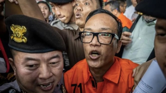 Wamenaker Immanuel Ebenezer berjalan menuju mobil tahanan