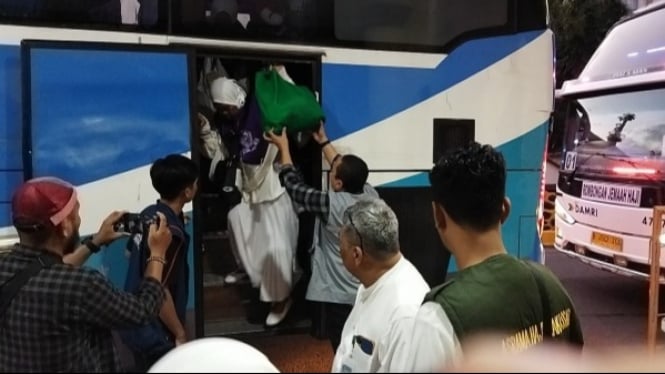 Petugas membantu Rombongan Jemaah Calon Haji turun